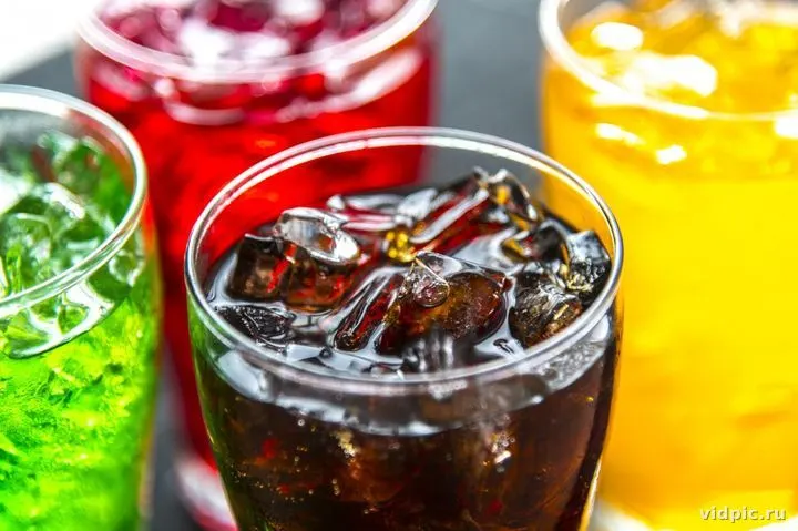 Glass of drink with ice. A glass of dark drink filled with ice is shown in the image.