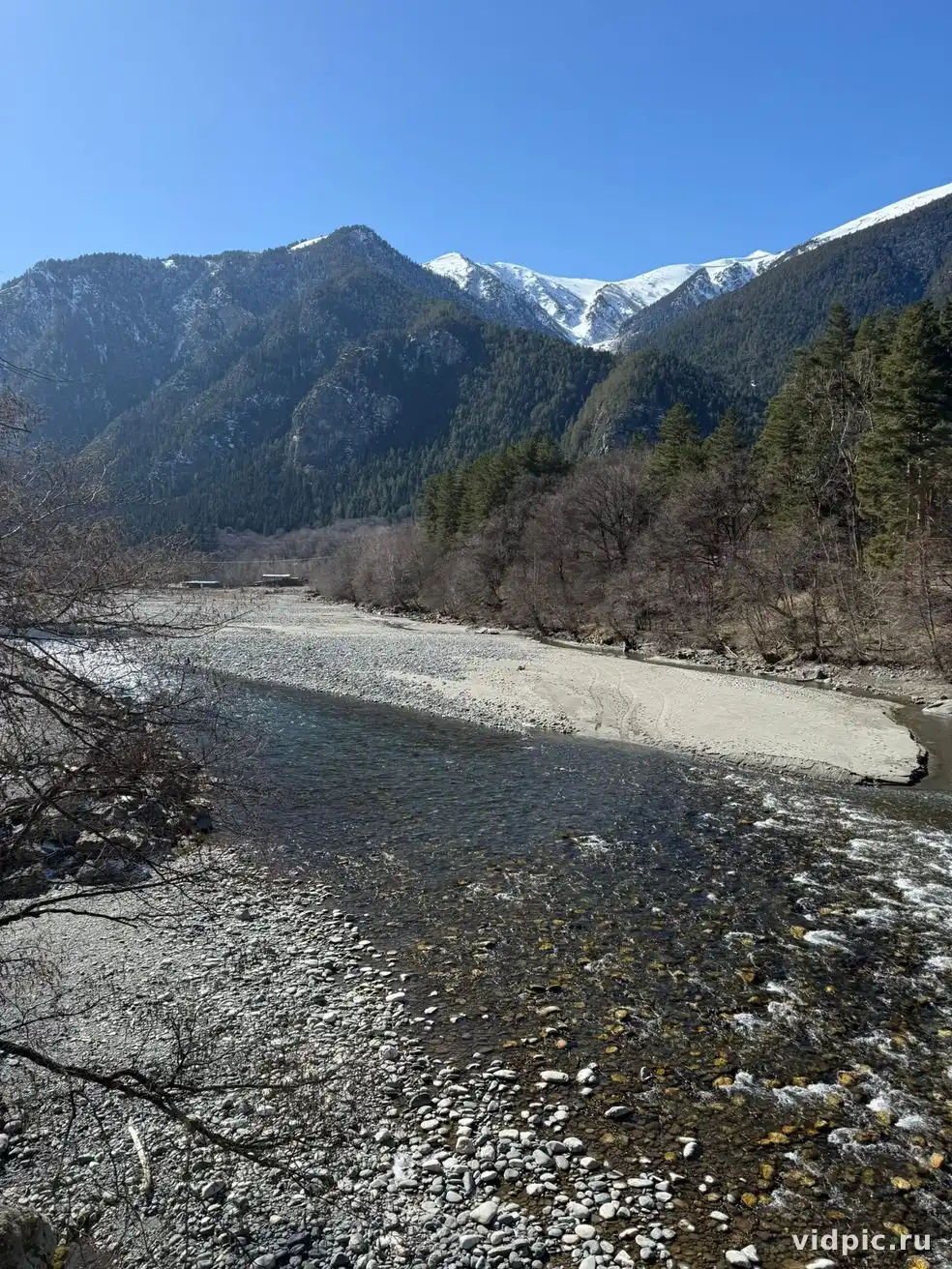 Mountains, river and forest. A landscape with a mountain river surrounded by forest and mountains.