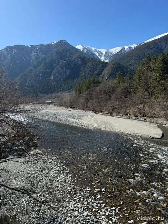 A landscape with a mountain river surrounded by forest and mountains. Perfect for illustrating nature and travel.