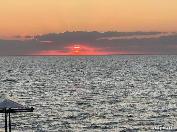 A sunset over the sea with the sun setting into the water. Perfect for relaxation and inspiration.