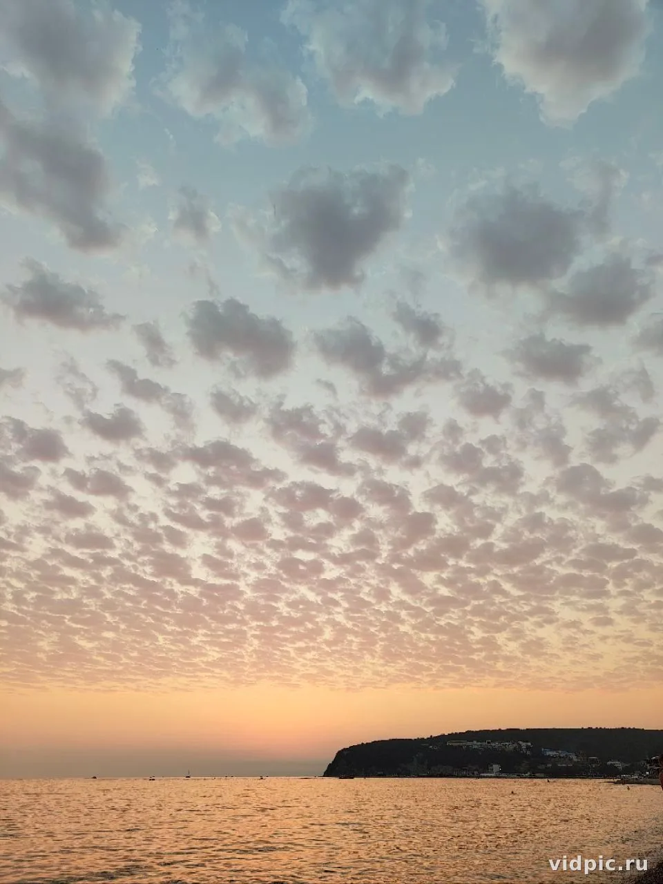 Sunset over the sea with pink clouds