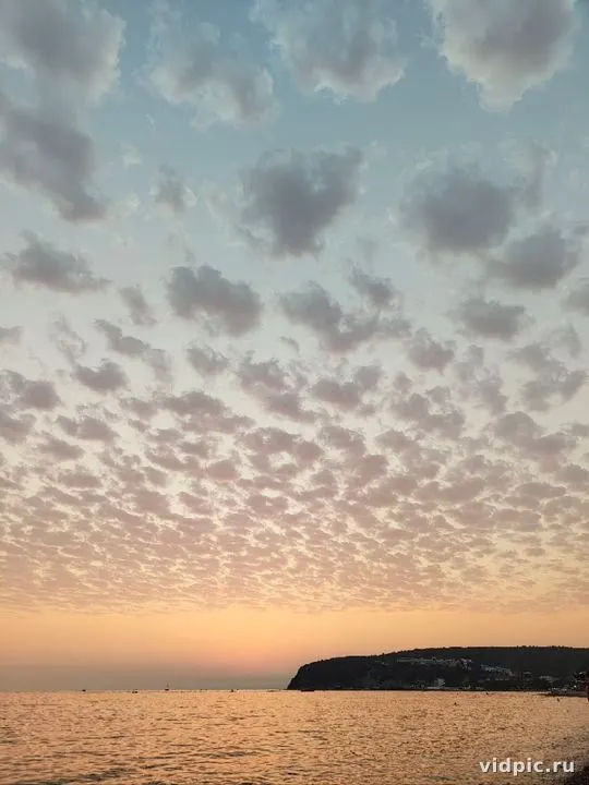 Sunset over the sea with pink clouds