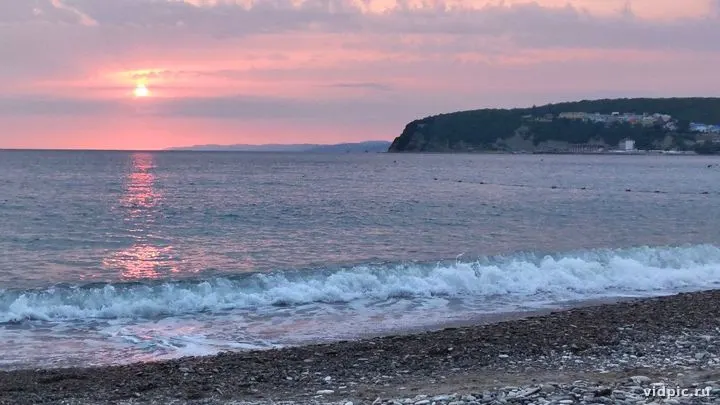Sunset over the sea with pink and purple hues. A sunset over the sea with pink and purple hues in the sky.